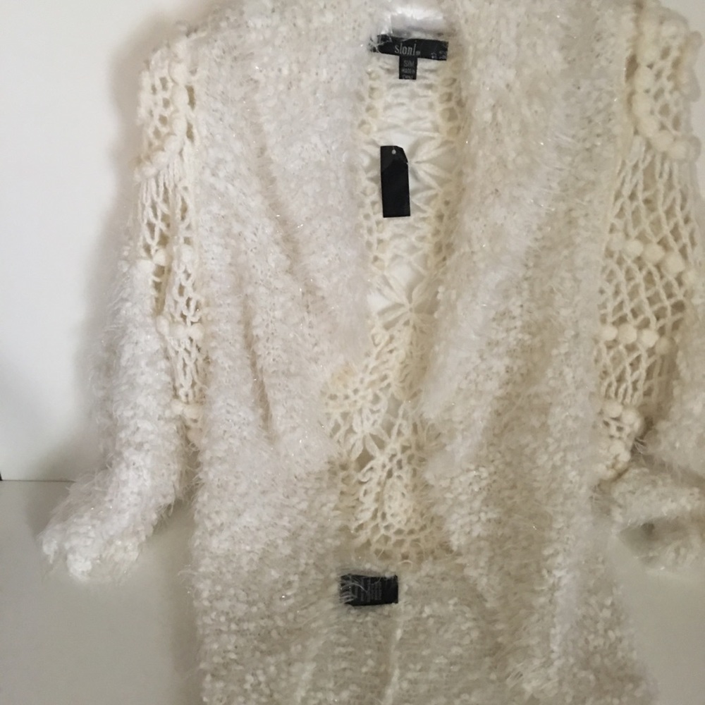 One sequined tank top. A white sweater. Selling 2